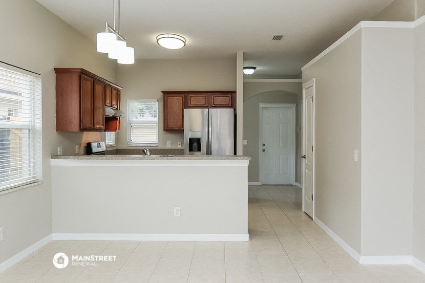 an empty kitchen with a counter top in a house