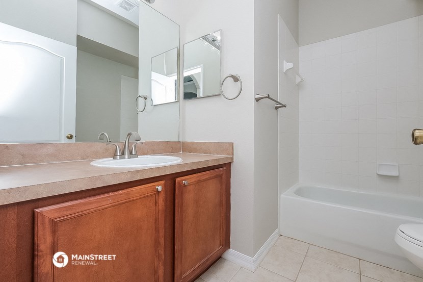 a bathroom with a sink and a mirror and a shower
