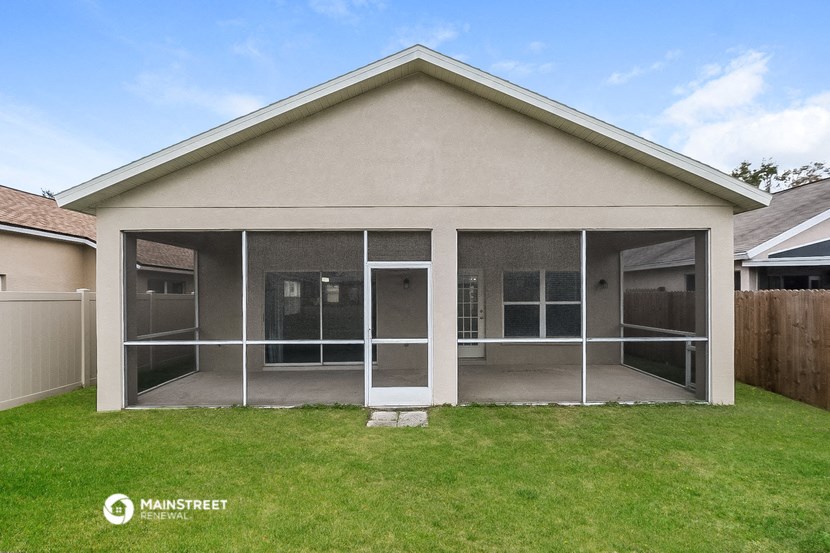 a patio with glass doors in front of a house