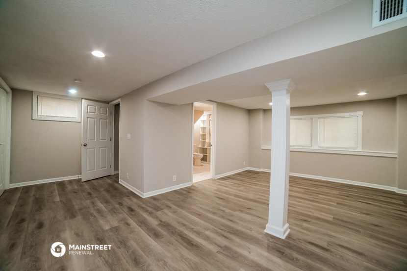 the upstairs living room and dining room with hardwood flooring