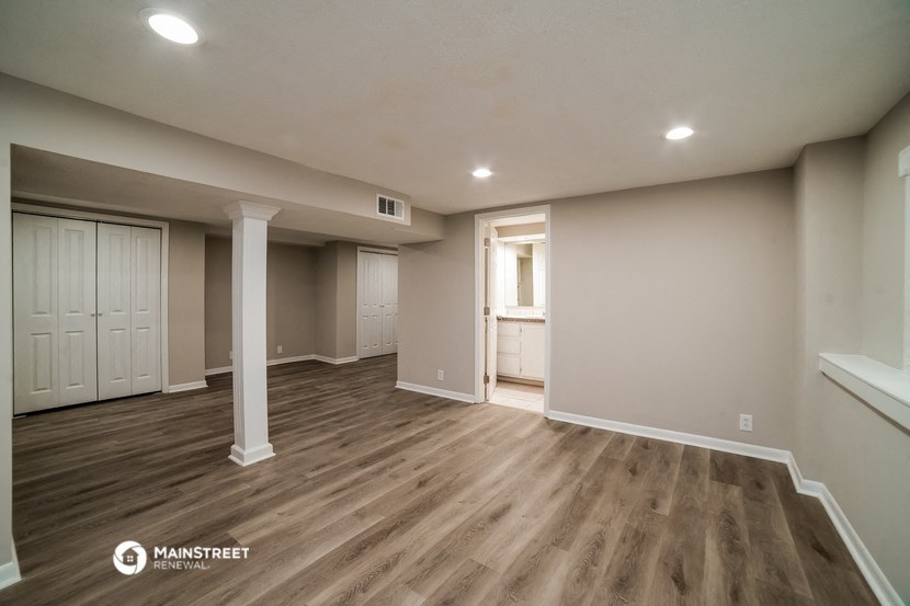 the upstairs living room of a new home with wood flooring