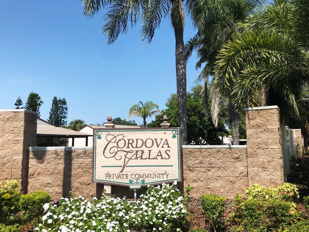 A sign for Cordo Vallas Private Community is displayed in front of a wall.