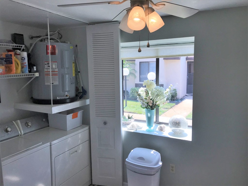 A small laundry room with a washer and dryer.