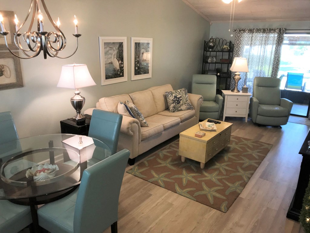 A living room with a couch, chairs, and a coffee table.