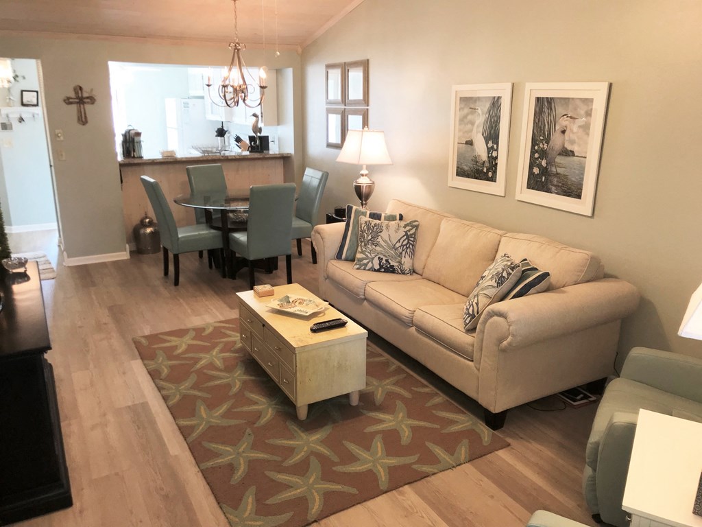 A living room with a couch, chairs, and a coffee table.