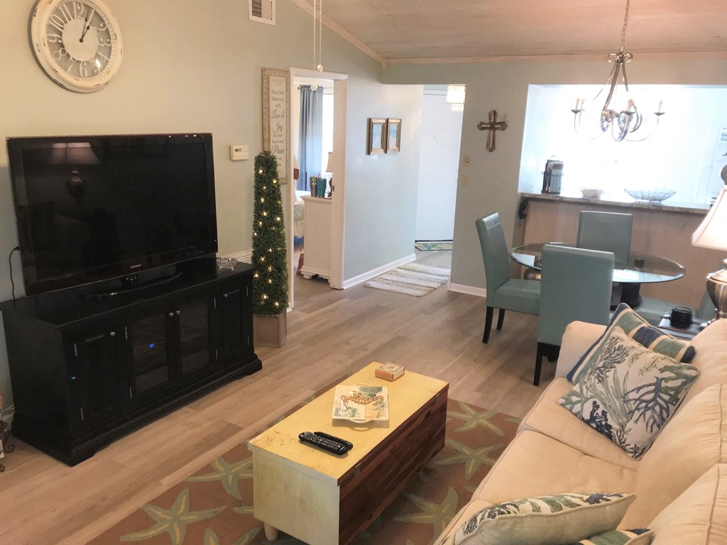 A living room with a television, a couch, and a coffee table.