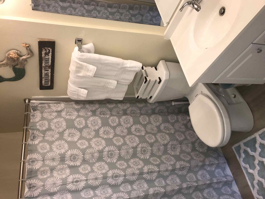 A bathroom with a towel hanging on the towel rack.