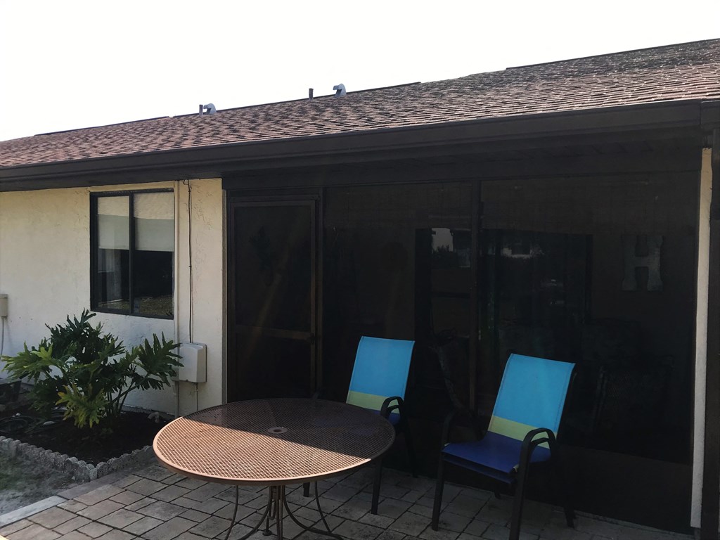 A patio with a table and two chairs.