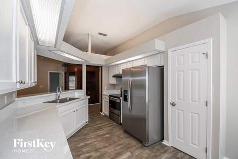 a kitchen with stainless steel appliances and white cabinets
