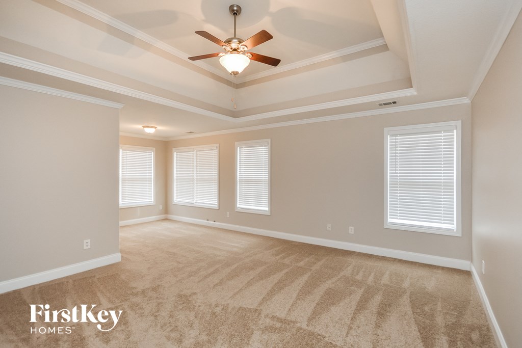 the living room of a new home with a ceiling fan