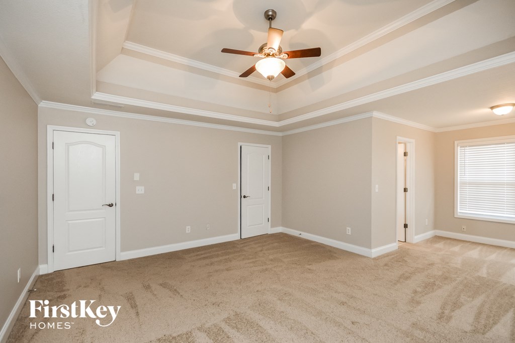 the living room of a new home with a ceiling fan