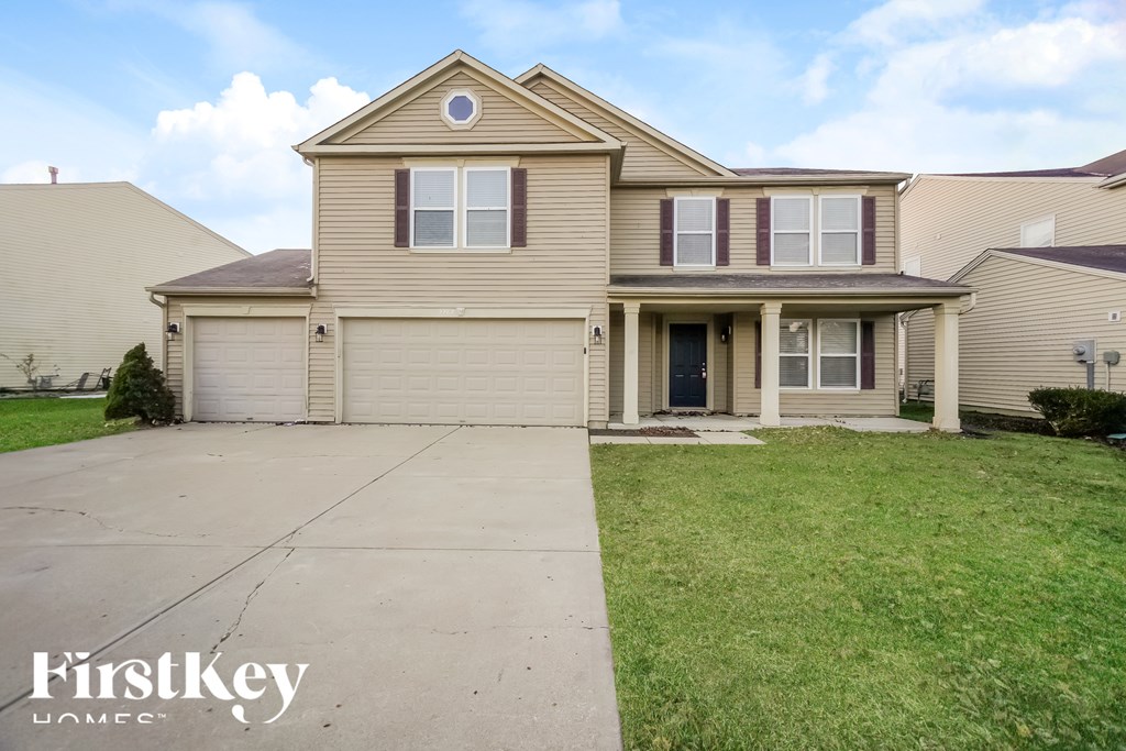 A two-story house with a garage is for sale.