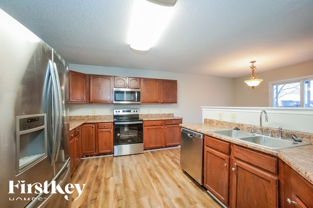 A kitchen with wooden cabinets and stainless steel appliances.