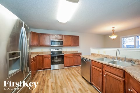 A kitchen with wooden cabinets and stainless steel appliances.