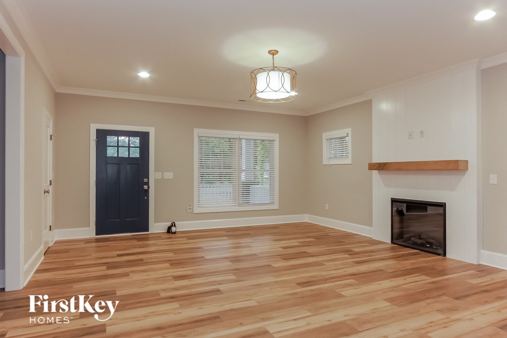 the living room with hardwood floors and a fireplace