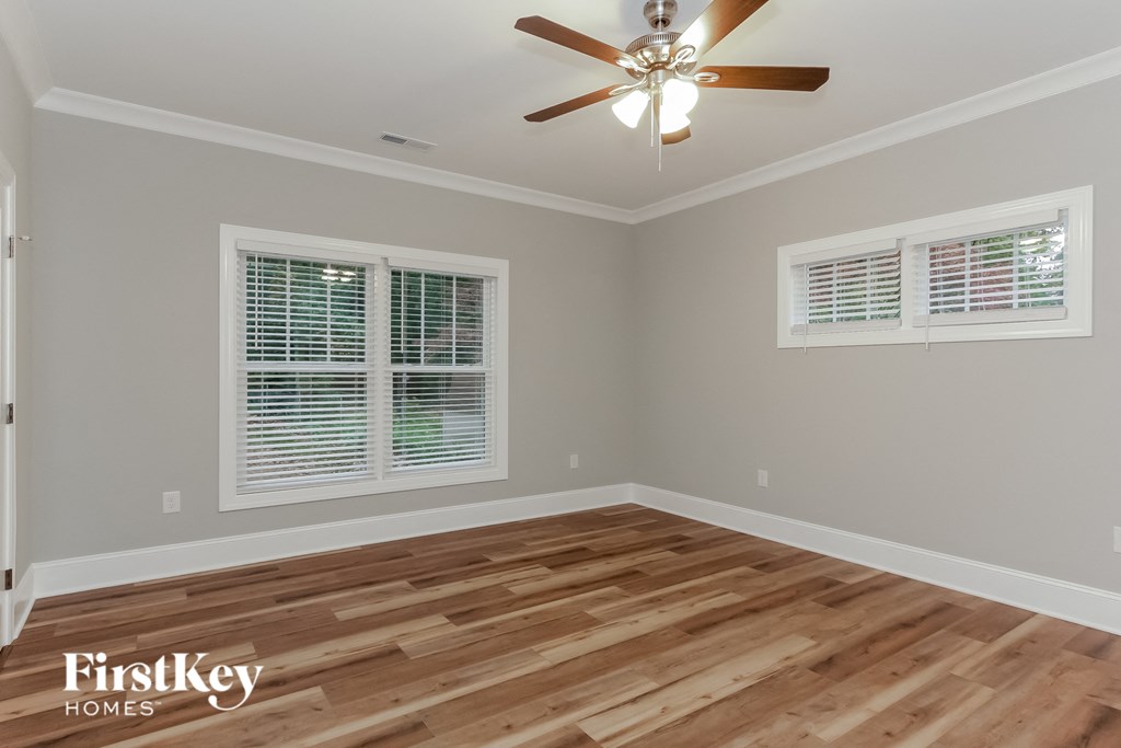 the living room with hardwood floors and a ceiling fan
