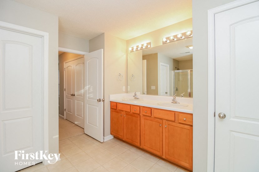 a bathroom with a sink and a mirror and a shower