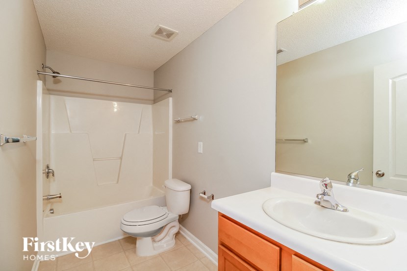 a bathroom with a sink toilet and a shower