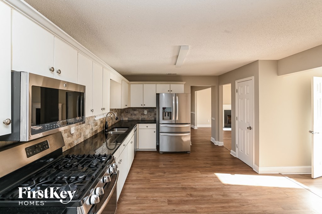 a kitchen with stainless steel appliances and white cabinets