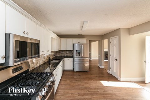 a kitchen with stainless steel appliances and white cabinets