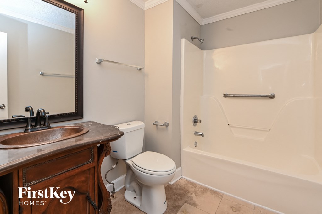 a bathroom with a toilet and a tub and a sink