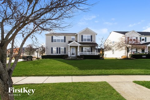 a white house with a lawn and a sidewalk