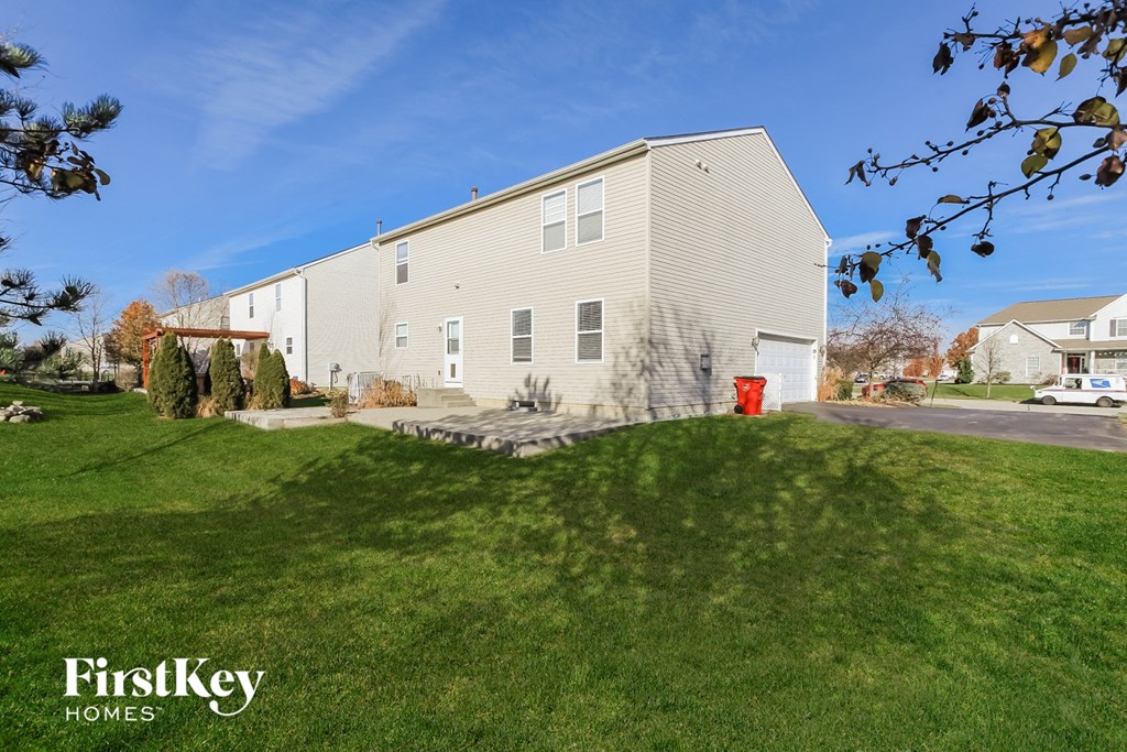 a white house with a yard in front of it