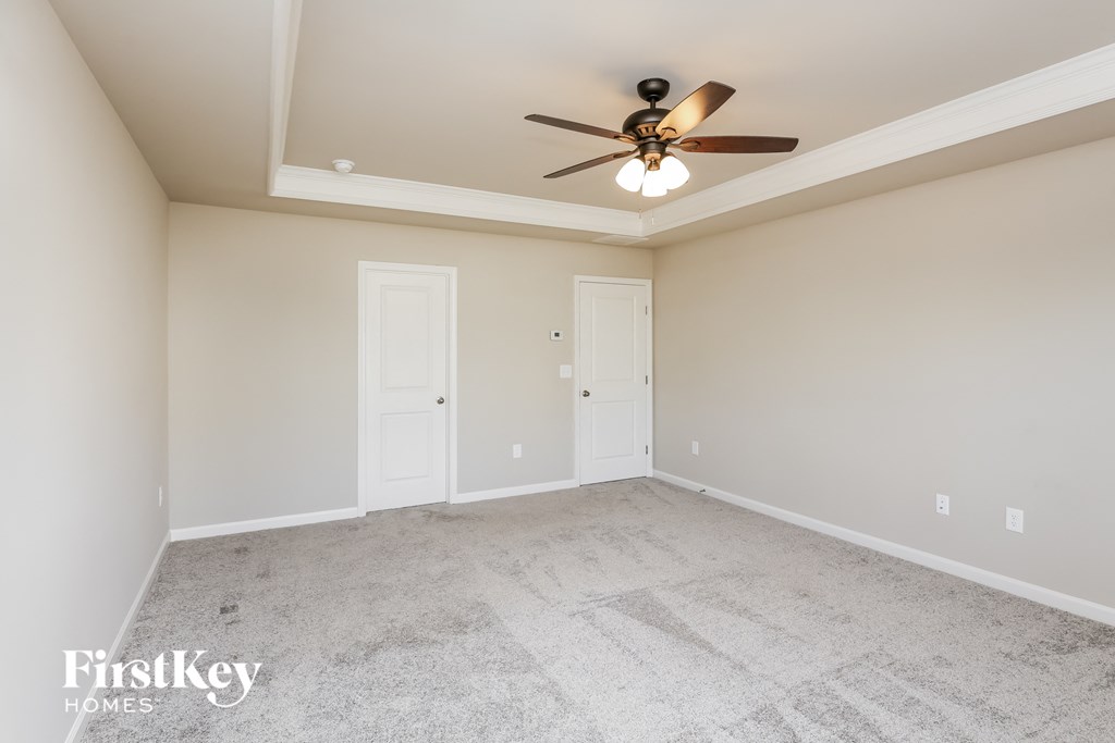 a empty living room with a ceiling fan
