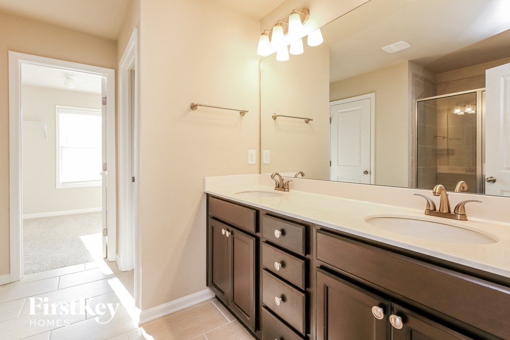 a bathroom with a large mirror and a sink