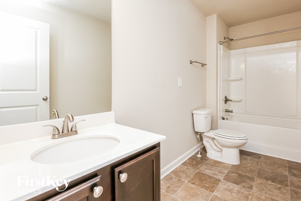 a bathroom with a sink and a toilet and a shower