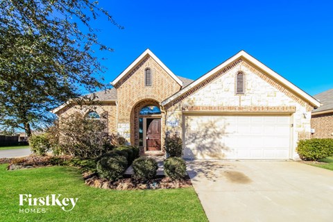 a large brick house with a white garage door