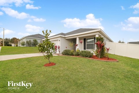 a home with a lawn and plants in front of it