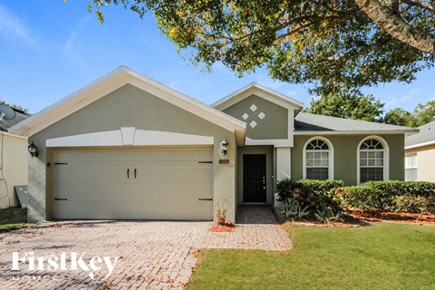 a house with a garage door and a lawn
