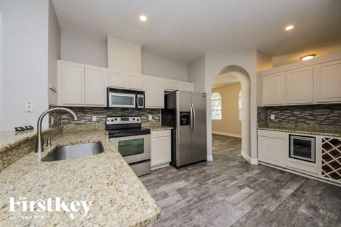 a kitchen with stainless steel appliances and white cabinets