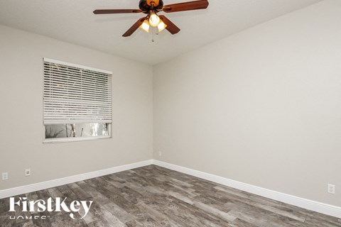 a living room with a ceiling fan and a window