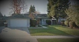 a house with a garage and a lawn in front of it