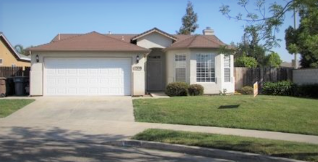 a house with a white garage door and a lawn