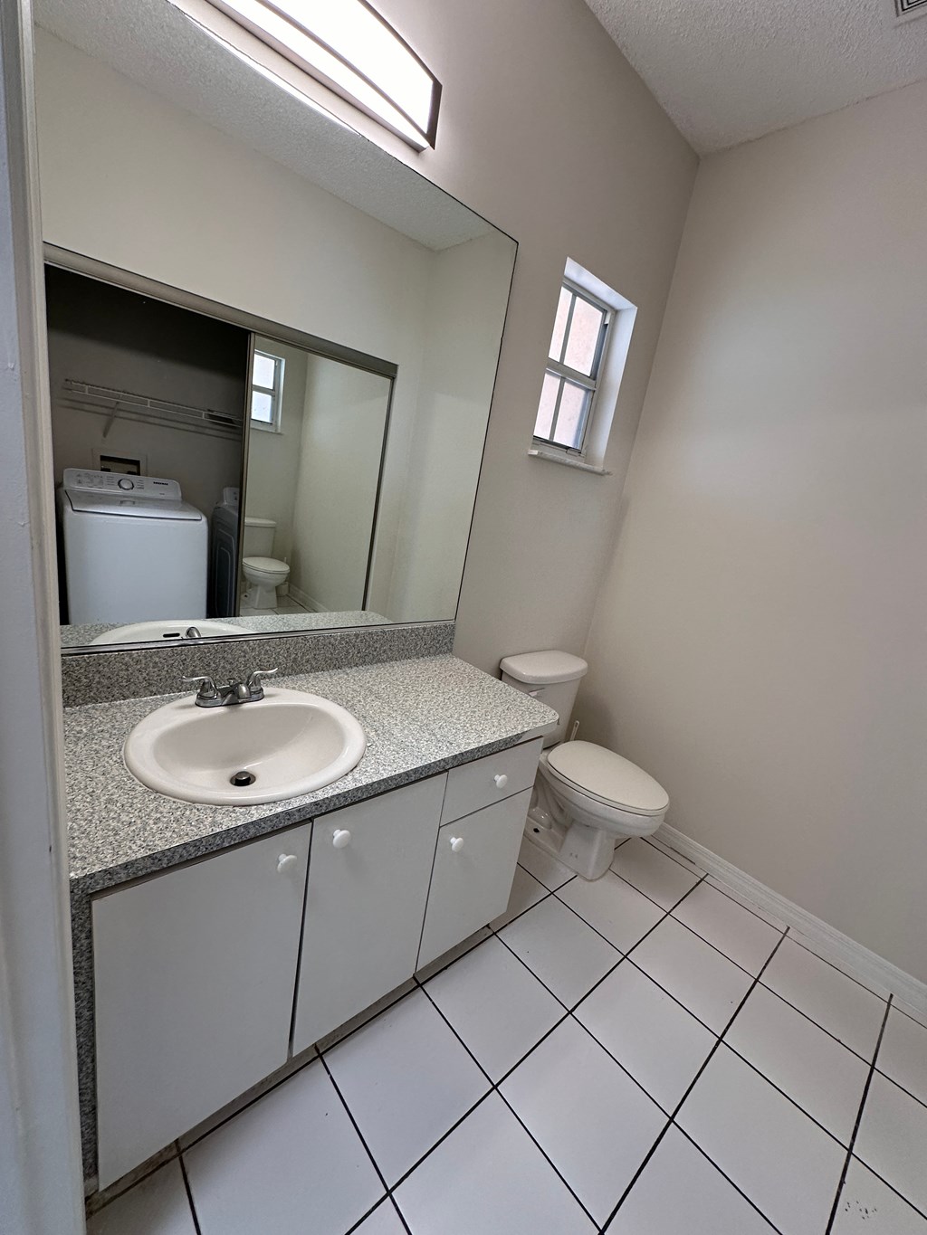 an empty bathroom with a sink and a toilet