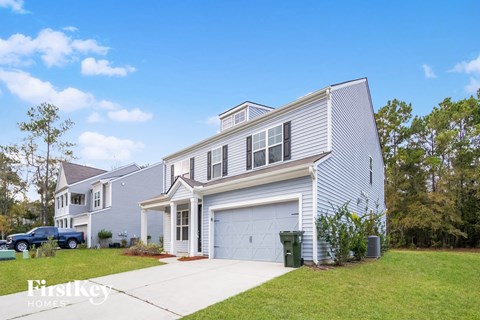 A two-story house with a garage and a driveway.