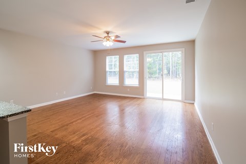 A room with wooden floors and a ceiling fan.