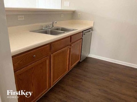 A kitchen with wooden cabinets and a white countertop.