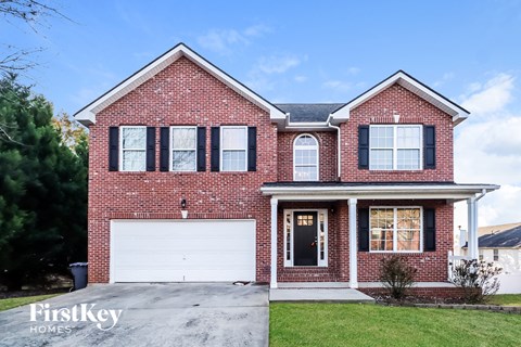 a red brick house with a white garage door