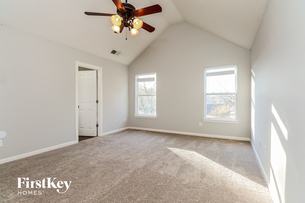 the master bedroom is spacious and has a ceiling fan