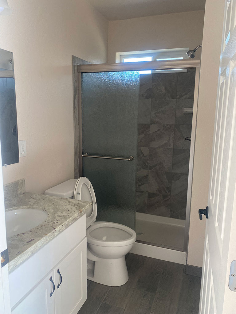 a bathroom with a toilet and a shower