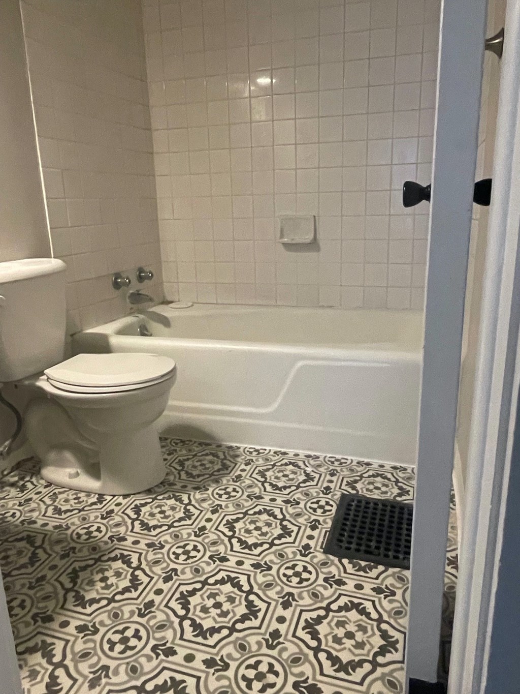 a bathroom with a toilet and a bath tub