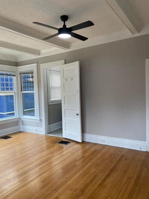an empty living room with a ceiling fan and a closet