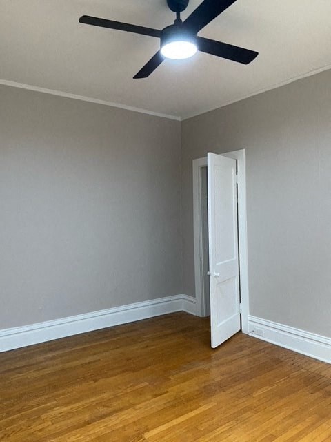 an empty room with a ceiling fan and a door