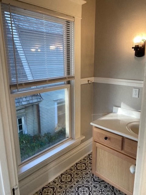 a bathroom with a large window and a sink