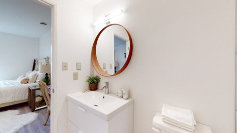 a white bathroom with a mirror and a sink