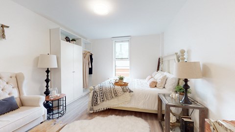 a bedroom with a bed and a couch and a closet